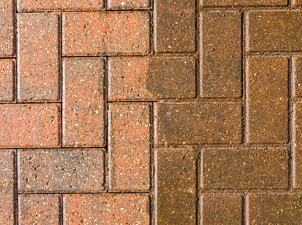 Block paving half jet washed and half still dirty stock photo