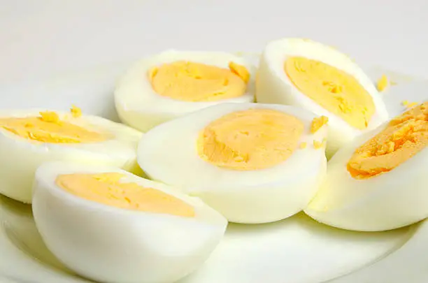 Eggs boiled hard-boiled on a light background.