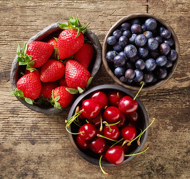 istock Summer berries on wooden table, from above 537395216