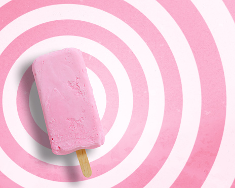 Ice cream stick on circle pattern pink and white background with copy space.,Pastel tone.