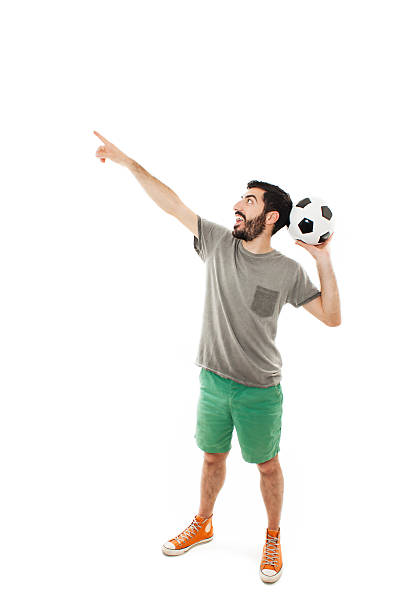 istock Excited man holding football, pointing 537396776
