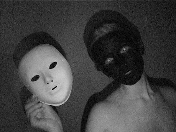 istock White woman face peint in black with a white mask 537396968