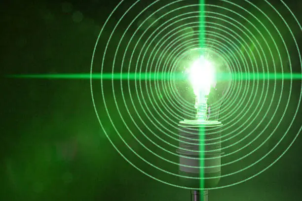 Photo of Glowing green bulb is emitting circular data