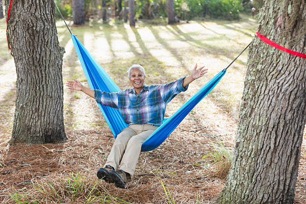 istock Happy senior black woman sitting on hammock 537398736