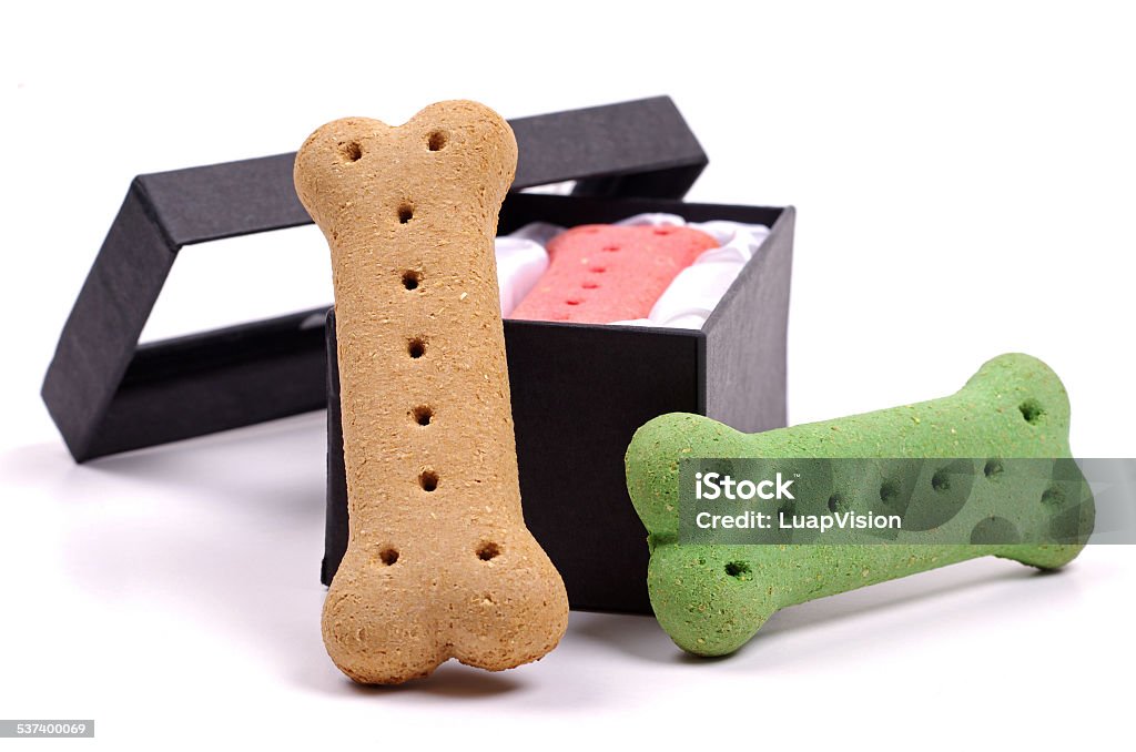 dog biscuits around a black box colored dog treats in and around a black presentation box  Box - Container Stock Photo