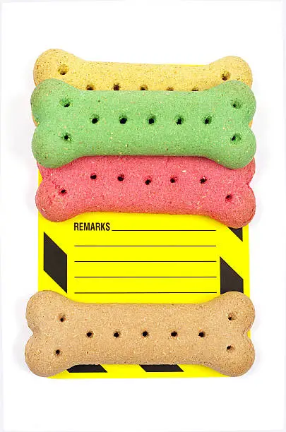 dog biscuits and a yellow remarks card on a white background 