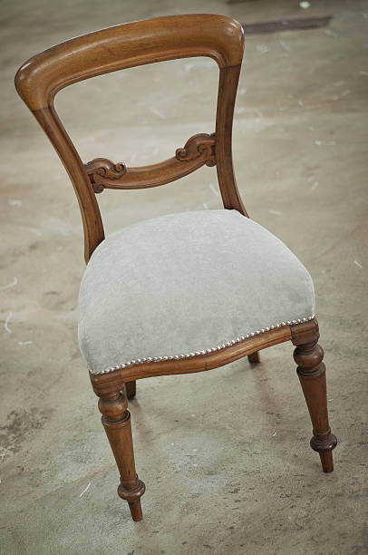 closeup of upholstery tacks on an old traditional wooden chair