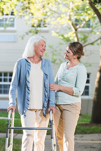 istock Women using walker, with adult daughter 537400174