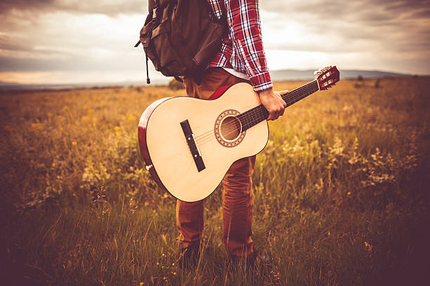 Guitarist Photo of young man in nature with guitar Slective Focus stock pictures, royalty-free photos & images