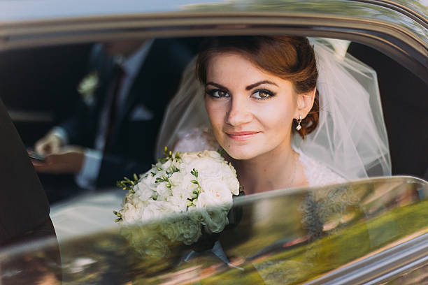 istock Happy young couple in luxurious car after their wedding. Focus 537401314