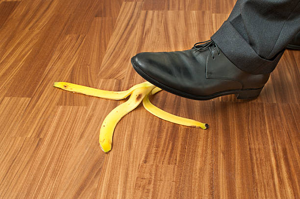 istock Businessman stepping on banana peel 537401397