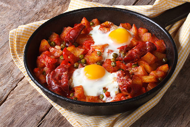 Eggs to the flamenco, closeup. horizontal Spanish Food: eggs over Flemish, a pan closeup. horizontal benelux stock pictures, royalty-free photos & images