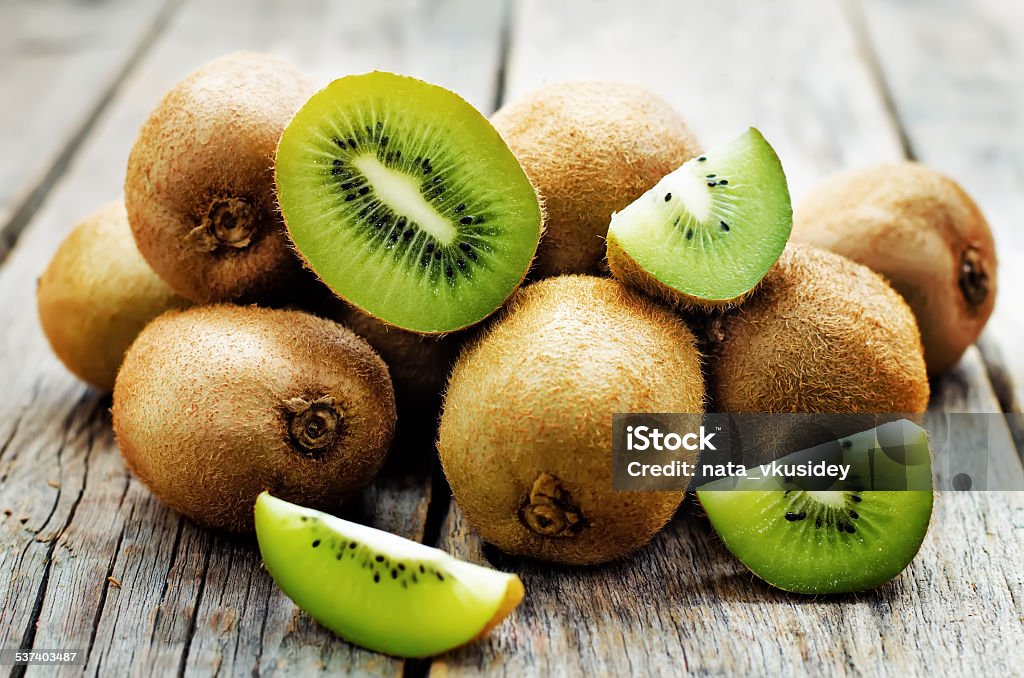 kiwi kiwi on white wood background. tinting. selective focus Kiwi Fruit Stock Photo