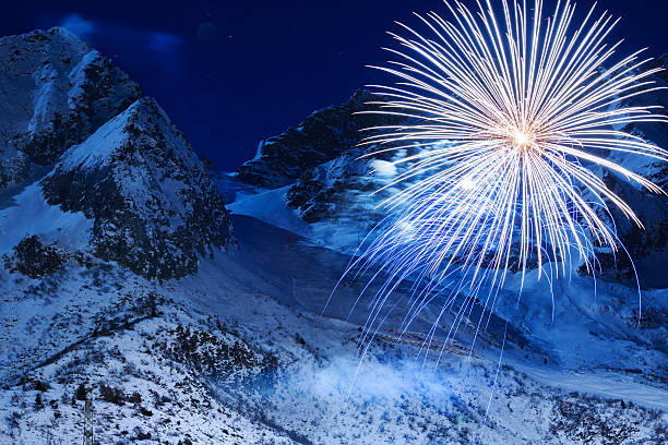 Brightly colorful fireworks. Night skiing.  Panoramic view of  high mountain winter landscape Passo Tonale ski area. Passo del Tonale is a wide, panoramic, natural amphitheatre lying between 1,884 and 3,100 metres above sea level.  The grain and texture added.
