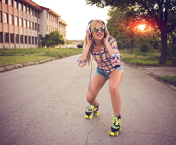 istock Woman roller skating and dancing on the road 537404640