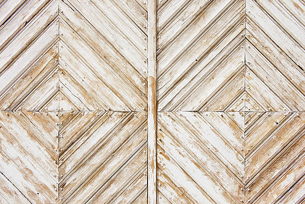 istock Rhomb pattern of the old weathered white-painted wooden gate. 537405274