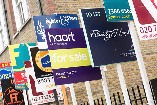 London, England, United Kingdom - February 11, 2015: FOR SALE and TO LET real estate agent sign boards outside residential housing development in Hackney.