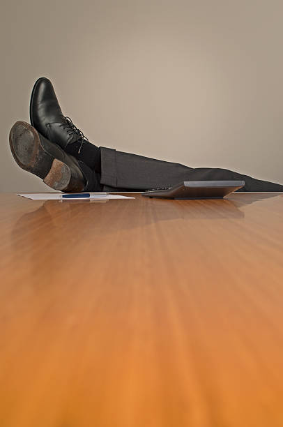 istock Businessman with feet on desk 537406621