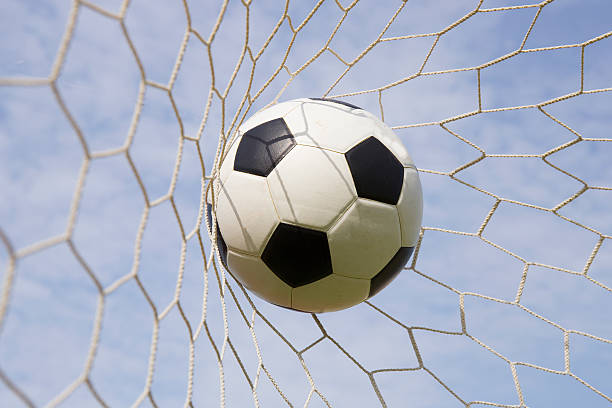 istock foot ball in the goal net 537407230