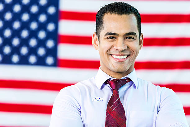 istock Smiling Hispanic Man in front of American flag 537407908