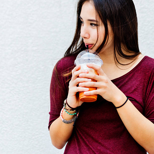 istock Woman Drinking Beverage Milk Tea Drinks Waiting Concept 537411034