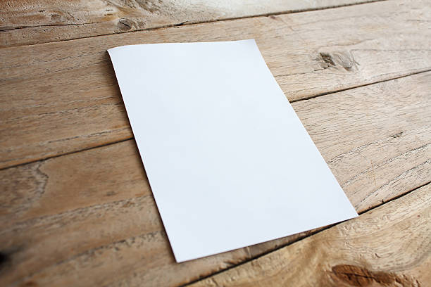 istock Blank paper on wood table 537416760