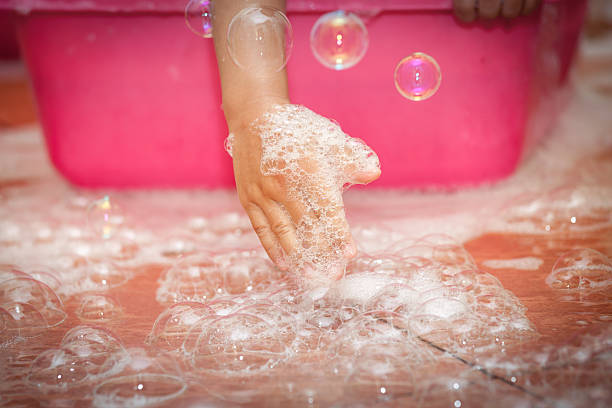 istock Child hand playing bubble on the floor 537417612