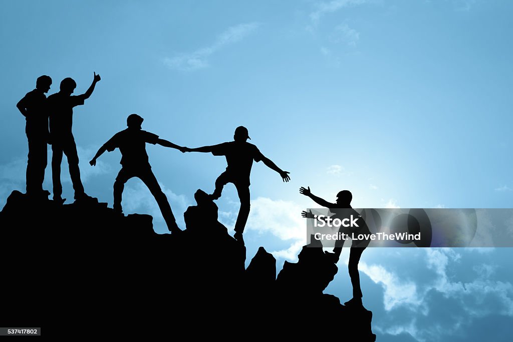 Group of people on peak mountain Group of people on peak mountain  climbing helping team work , success concept Leadership Stock Photo