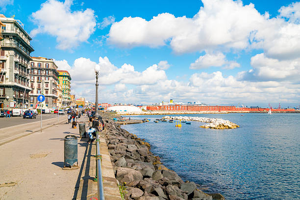 Naples, Italy - February 26, 2016: View of the seafront neighborhood, Chiaia in Naples, Italy. People can be seen walking around by the bay.
