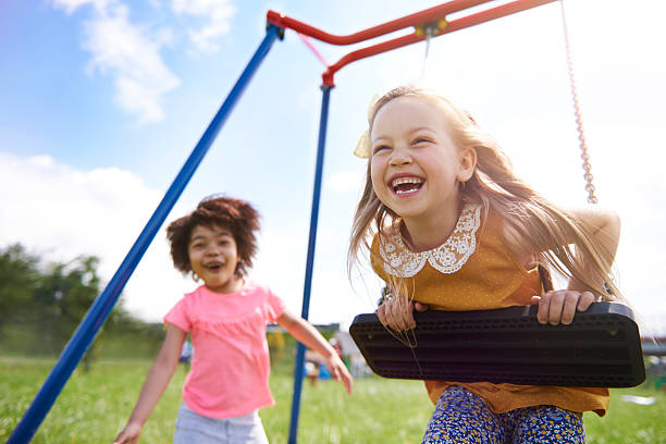 The best friends playing together The best friends playing together swing play equipment photos stock pictures, royalty-free photos & images