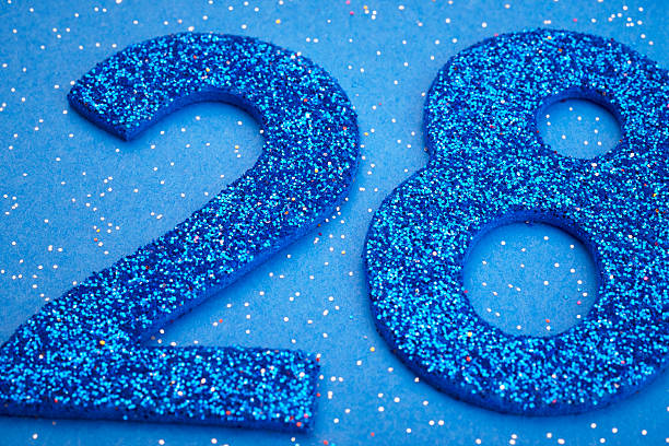 istock Number twentyeight blue color over a blue background. Anniversar 537425390