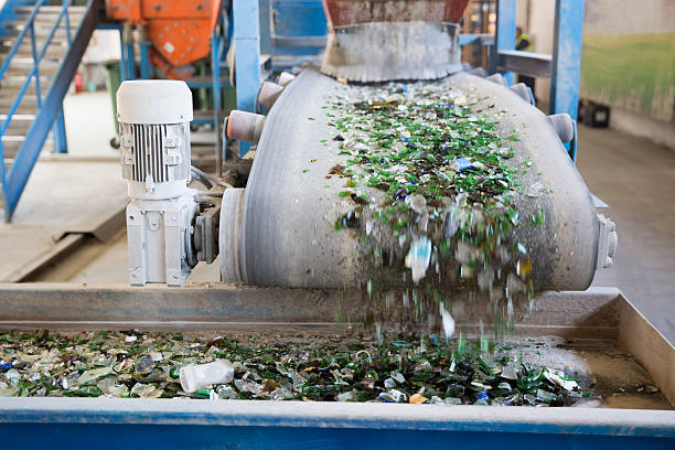 Glass waste in recycling facility. Glass particles Glass particles for recycling in a machine in a recycling facility. Different glass packaging bottle waste. Glass waste management. Glass recycling is the process of waste glass into usable products. recycling center stock pictures, royalty-free photos & images