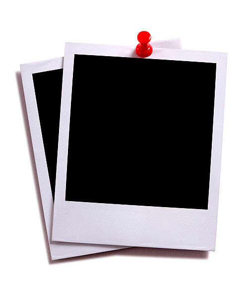 istock Two blank instant camera photo prints with red pushpin isolated 537433347