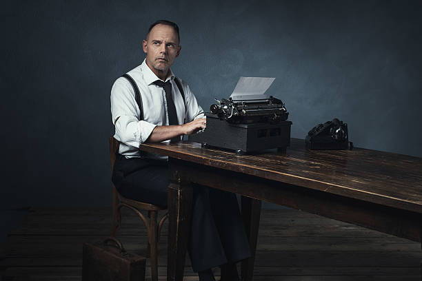 istock Retro 1940 office worker behind desk with typewriter and telephone. 537433834