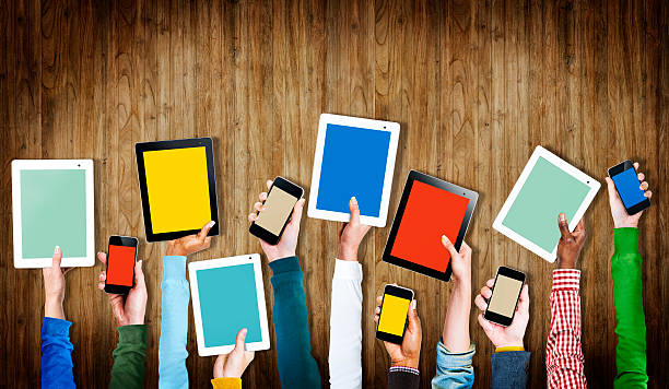 istock Group of Hands Holding Digital Devices with Copy Space 537434249