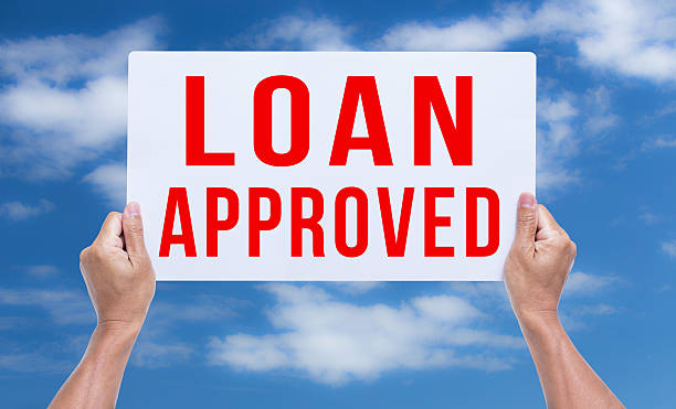 istock Two hands holding cardboard with loan approved 537434453