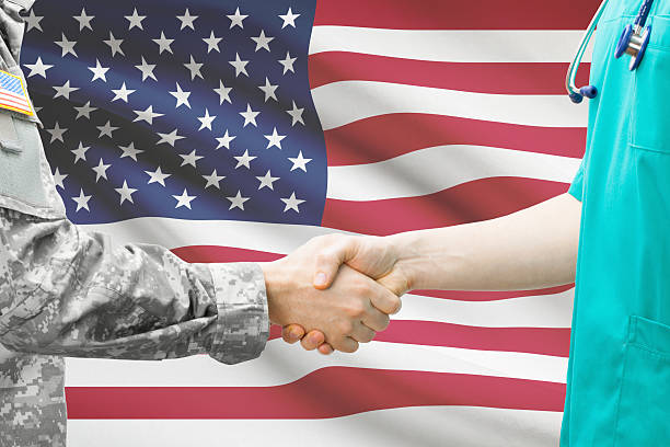 Soldier and doctor with flag on background - United States stock photo