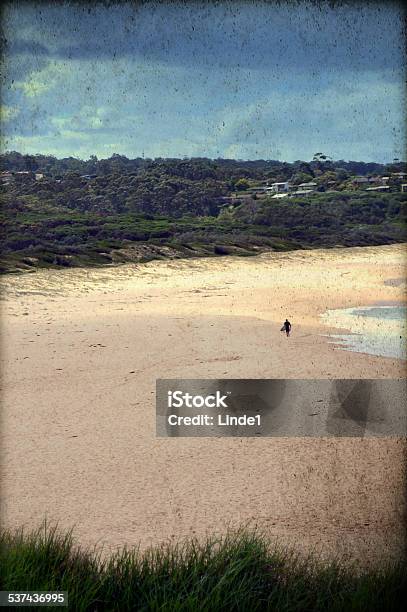 Grunge Retro Image Of Deserted Beach With Lone Surfer Stock Photo - Download Image Now