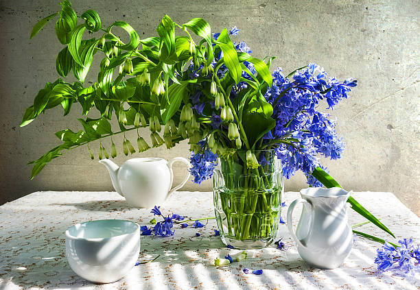 istock Still life bouquet polygonatum blue tones white crockery 537437872