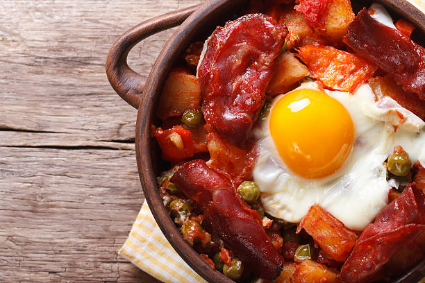 istock eggs with chorizo, potatoes and tomatoes in pot. closeup top 537438015