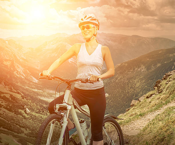 istock Woman stay on the bicycle around mountains 537438310