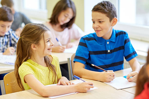 istock group of school kids writing test in classroom 537438727