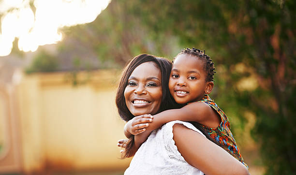 Mother and her  6 months old son on white background and smiling