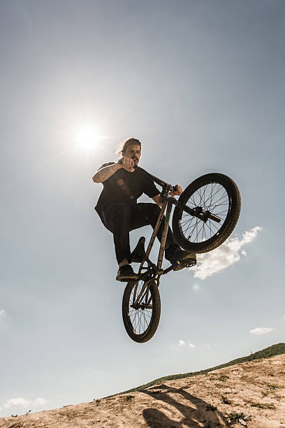 istock Extreme bicycle rider jumping against the blue sky. 537445146