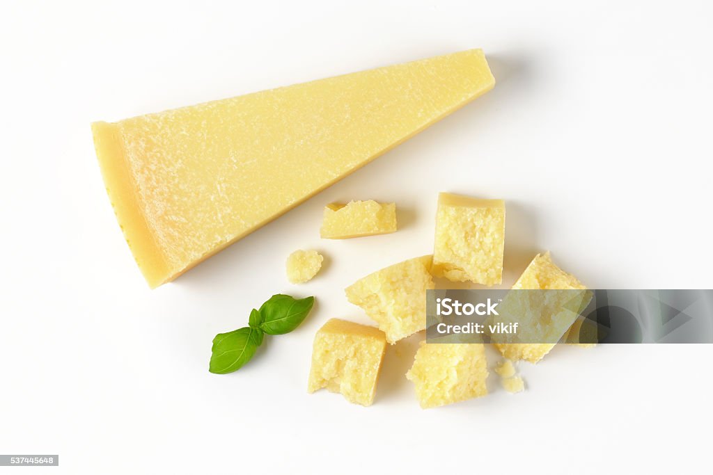 pieces of parmesan cheese wedge and pieces of fresh parmesan cheese on white background Cheese Stock Photo