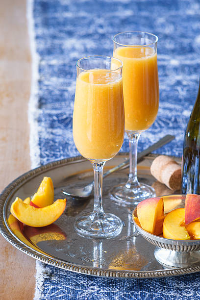 Two champagne flutes with Bellini coctail
