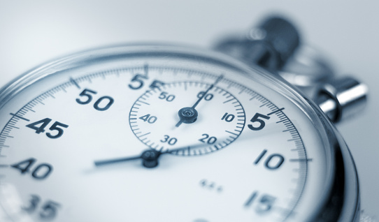 Analog stopwatch close-up with blurred second hand.