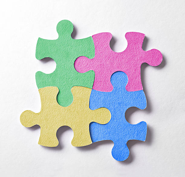 istock Four colorful puzzle pieces arranged in a square and bonded 537447256