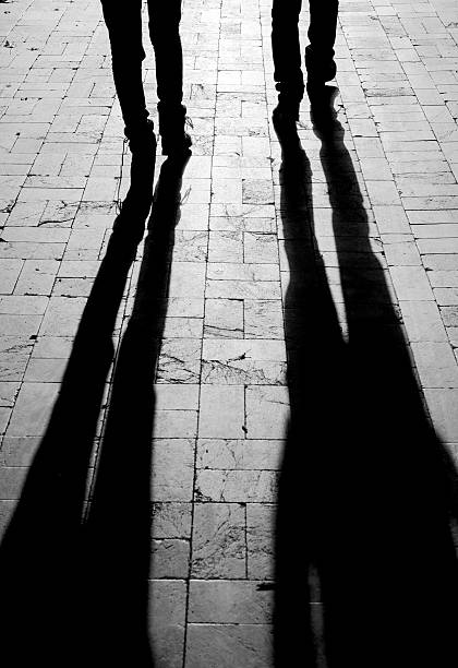 istock People shadows walking on city street 537448114