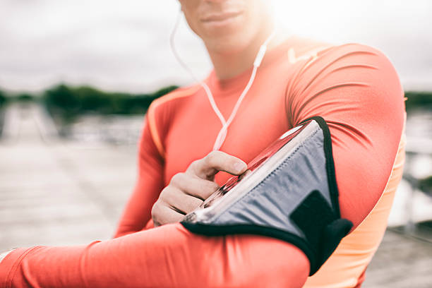 istock Runner man tuning his music player during jogging 537449194